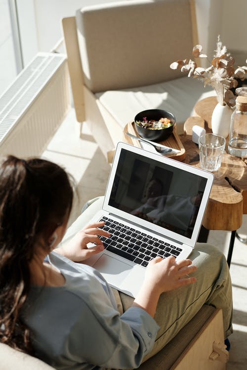 girl working on laptop behind