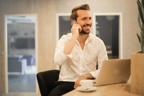 guy with beard on phone smiling